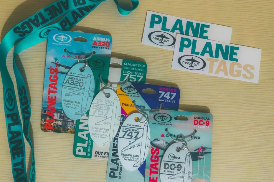 PlaneTags aircraft aluminum keychain collection featuring Delta DC-9, Thai Airways Boeing 747, Air Canada A320, and Boeing 757 tags"